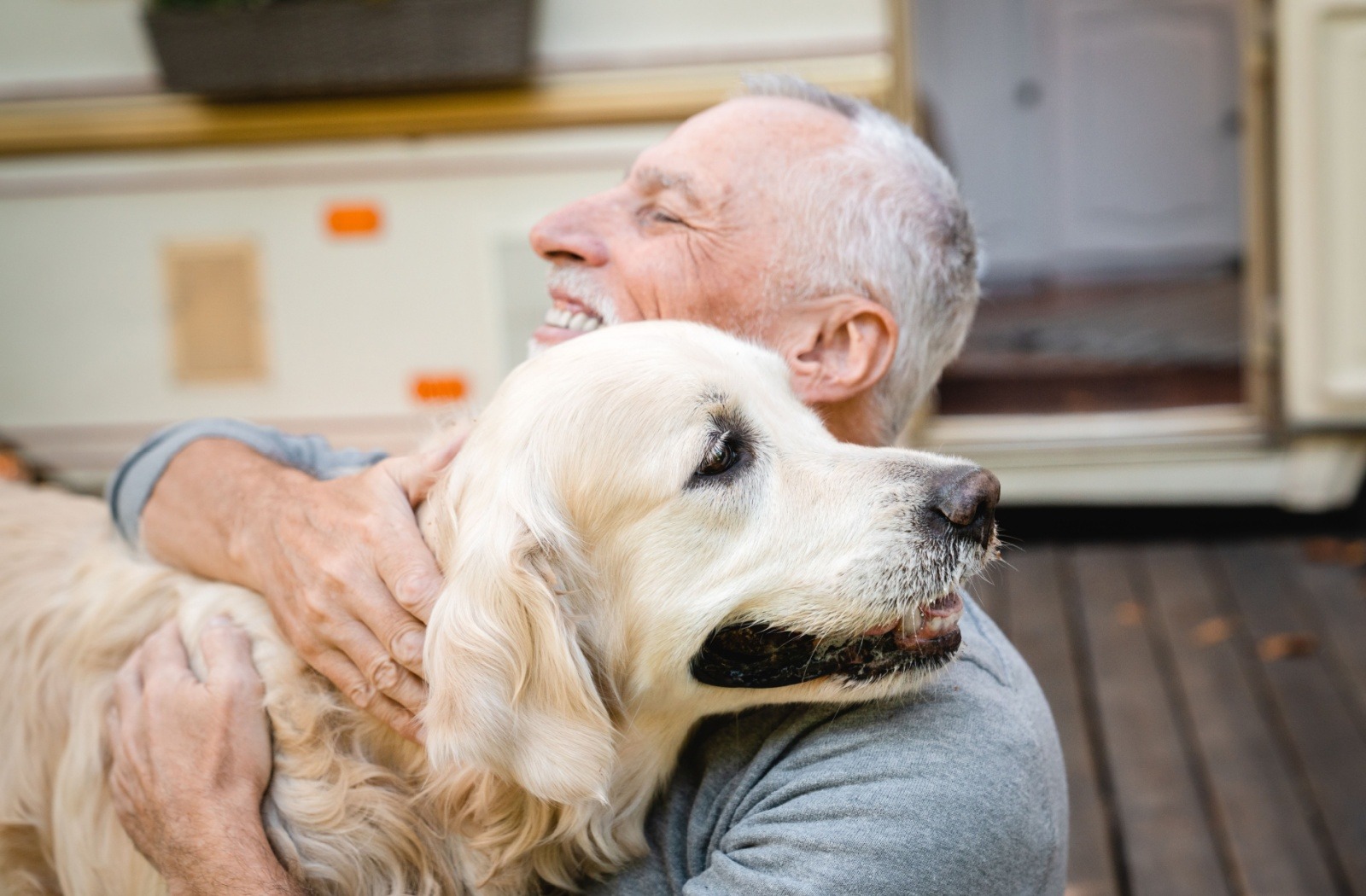 A senior resident hugs their beloved golden retriever.