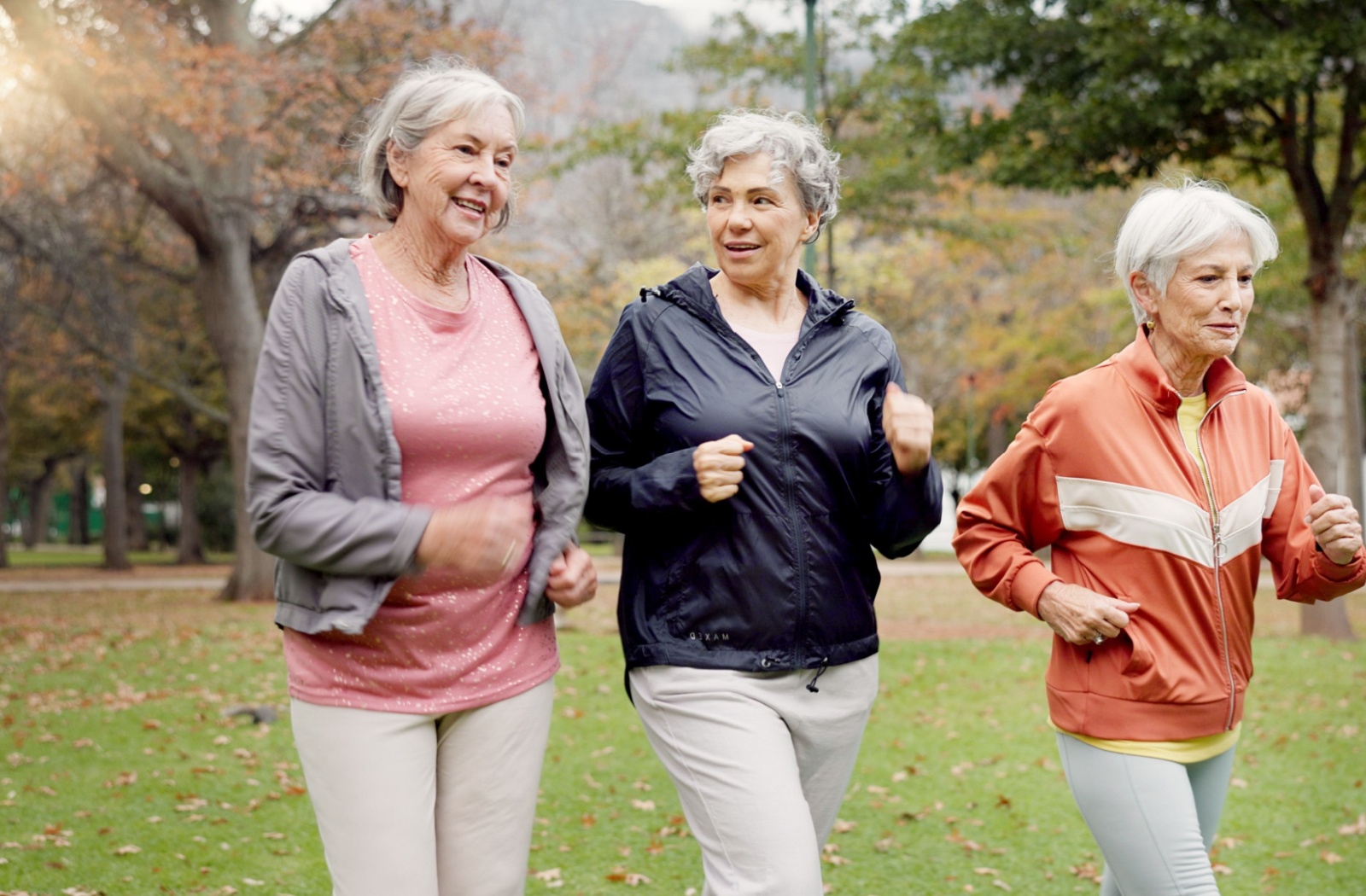 A group of senior women enjoying a walk together outside to get some cardio exercise.