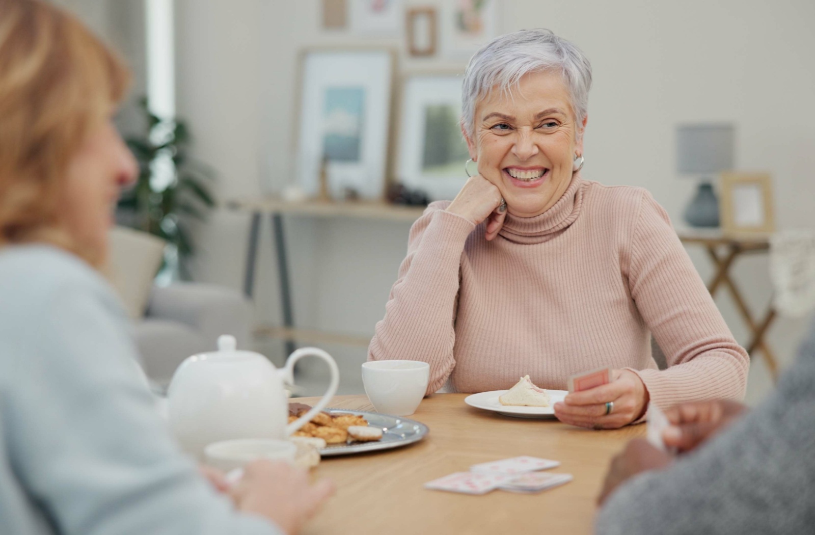 3 seniors share tea & laughter in an independent living community.